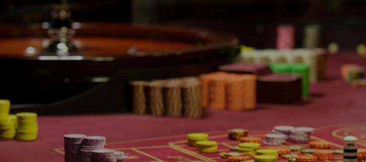 view of roulette table full of chips being bet on different numbers